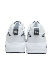 White athletic shoes with a textured mesh upper, gray accents, a padded collar, and a thick rubber sole. Features logo on heel.