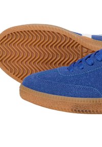Blue suede sneakers with a textured finish, rubber gum outsole featuring wavy patterns, and contrasting light stitching details.