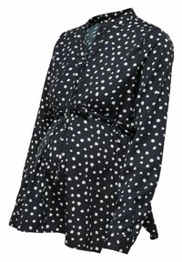 Blusa per maternità in tessuto blu navy con pois bianchi, dotata di un nodo in vita, maniche lunghe e scollo a V.