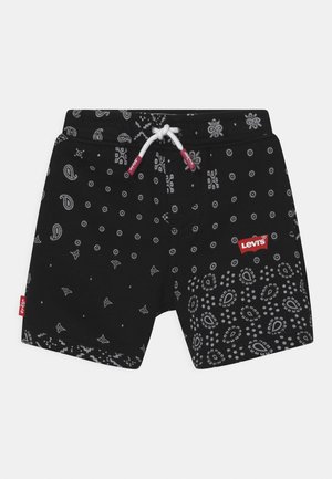 Pantalones cortos negros con patrones de paisley y flores en tonos grises. Cuentan con un cordón blanco y una etiqueta de logotipo roja de Levi's en la cinturilla.