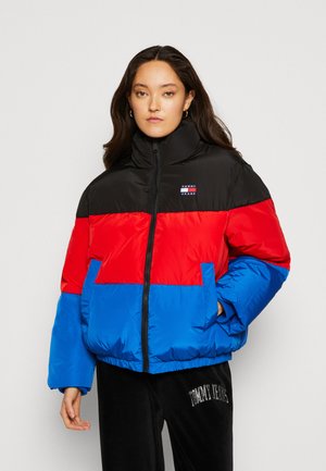 Padded jacket with black, red, and blue color blocks, high collar, front zip, and side pockets; made of glossy, quilted material.