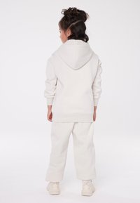 Champion EXCLUSIVE HOODIE UNISEX - Sportinis megztinis - off-white