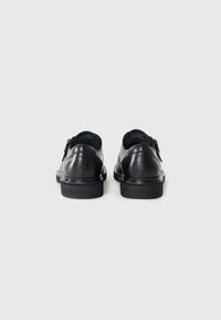 Black leather shoes with a matte finish, featuring a rounded toe and low heel, single buckle hardware, and smooth texture on the upper.