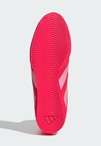 Suola di sneaker rosa brillante con un motivo ondulato testurizzato e accenti bianchi. Presenta un logo vicino al tallone e un design della punta arrotondata.
