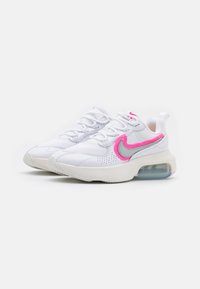 White sneakers featuring a mesh and leather upper, pink and gray accents, padded collar, and a visible air cushioning unit in the sole.