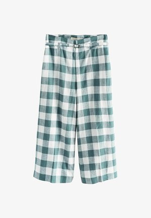 Højtaljede, vide, korte bukser med grønt og hvidt ternet mønster og et matchende bælte med sølvspænde.
