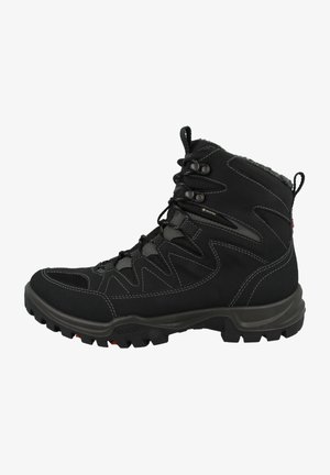 Black hiking boot with a high ankle design, synthetic upper, rubber sole, and lace-up front. Features reinforced stitching and textured accents.