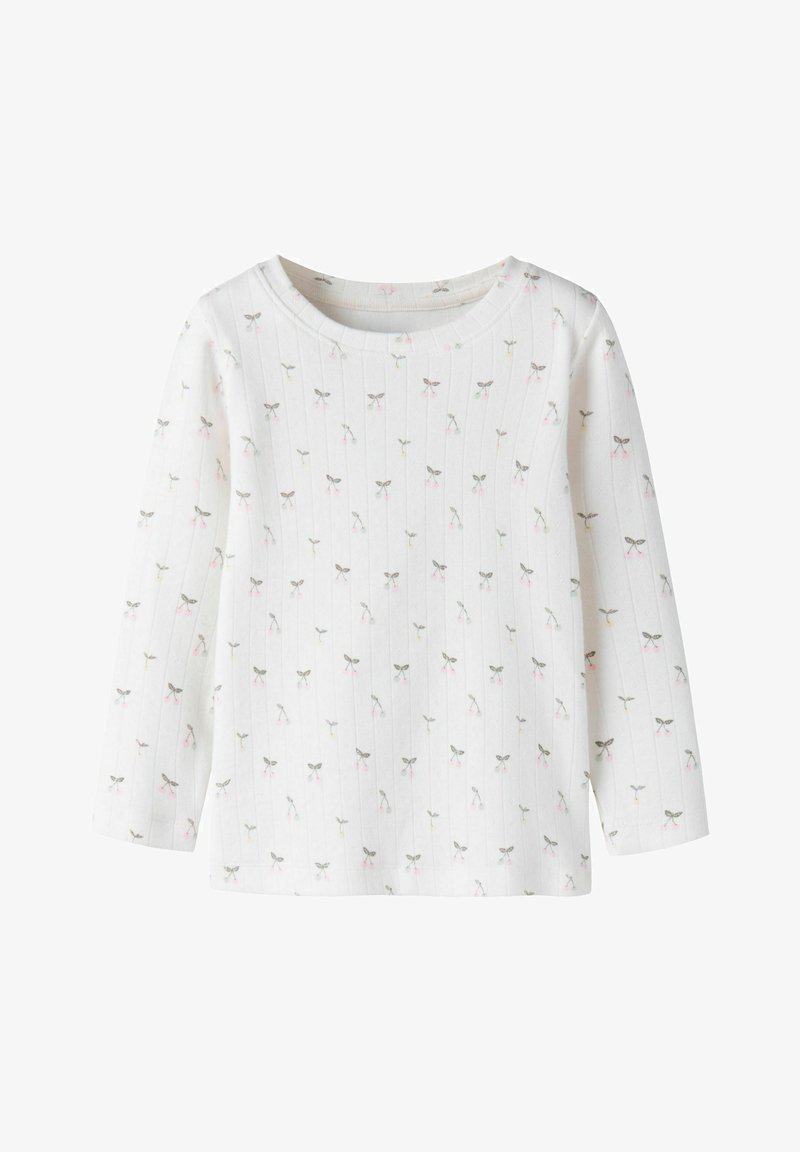Chemise blanche à manches longues en tissu côtelé avec un petit nœud gris et rose ainsi qu'un motif de fleurs partout.
