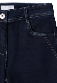 Tmavé džíny z denimu s hladkou texturou, s kontrastním žlutým stehem, přední kapsou a kovovým zapínáním.