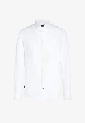Chemise blanche à manches longues, boutonnée, en coton, avec une coupe ajustée, col boutonné et poignets standards. Présente un logo discret sur l'ourlet.