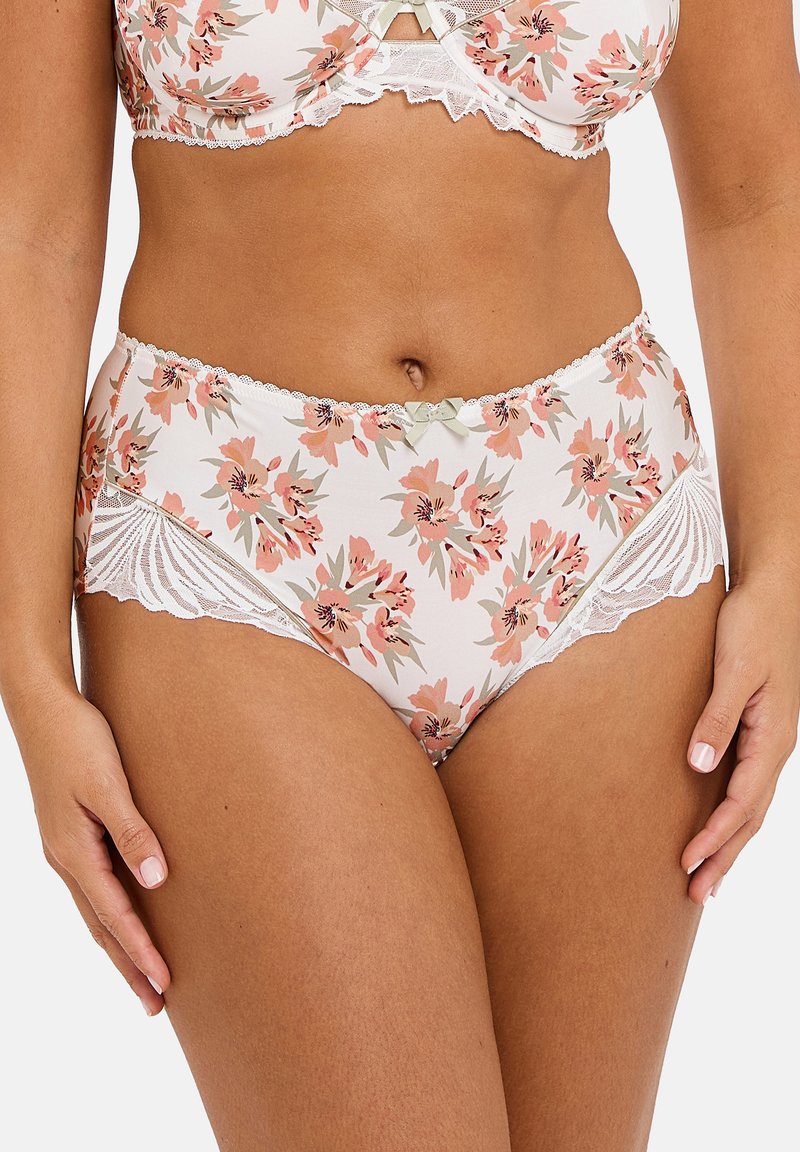 Ensemble de lingerie à motifs floraux avec des finitions en dentelle et de petits nœuds, porté par une femme à la peau medium sur un fond uni.