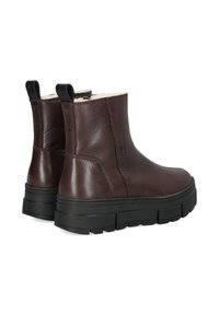 Braune Leder-Stiefeletten mit gepolsterter Innensohle, elastischen seitlichen Einsätzen und einer klobigen schwarzen Gummisohle. Mit Anziehhilfen an der Rückseite.