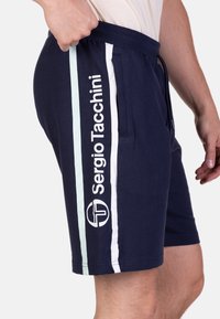 Marineblaue Shorts mit weißen und hellblauen Seitenstreifen, ausgestattet mit dem "Sergio Tacchini"-Logo und einem elastischen Bund für zusätzlichen Komfort.