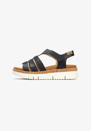Sandalias de cuero negro con suela de corcho, correas ajustables y suela de goma blanca. Presenta correas anchas y un diseño en capas.