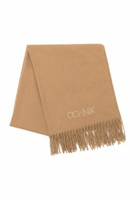 Jasnobrązowy szalik wykonany z miękkiego materiału, z frędzlami na krawędziach i dyskretnym haftem logo na jednym końcu. Klasyczny prostokątny kształt.