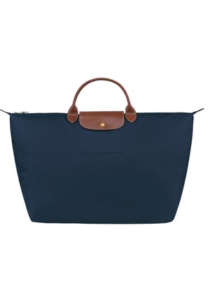 Navy blue nylon tote bag with a brown leather handle and top closure. Features a front pocket and minimalistic design. Lightweight and spacious.
