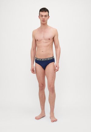 Mænds marineblå boxershorts lavet af blødt stof, med en sort elastik der har hvid "justcavalli" branding, tætsiddende design.