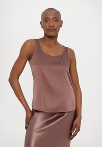 Satin mauve tank top with a scoop neckline and sleeveless design, paired with a matching satin skirt, smooth texture, and relaxed fit.