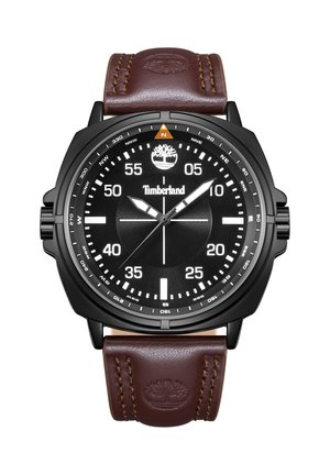 Čierne okrúhle hodinky Timberland s bielymi číslami, orientačnými značkami, tromi ručičkami a hnedým koženým remienkom s vyrazeným logom stromu.
