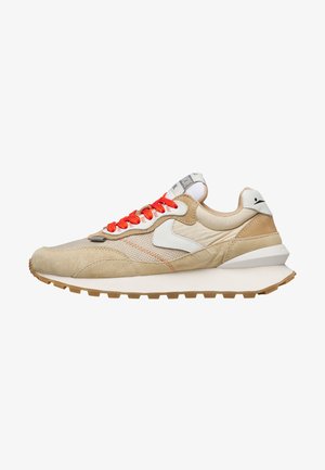 Beige and tan sneaker with white accents, bright orange laces, and a thick white sole with a textured gum outsole.