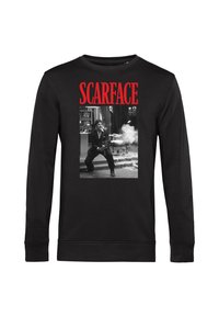 Schwarzes Langarmshirt mit rotem "SCARFACE"-Text und einem schwarz-weißen Foto eines Mannes, der drinnen mit einer Waffe schießt, umgeben von Rauch.