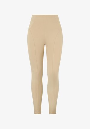 Leggings de tiro alto en color beige con una textura suave, que presentan un detalle de costura diagonal y un diseño ajustado. Sin bolsillos visibles.