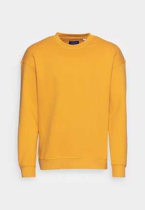 Geel sweatshirt van zachte stof. Beschikt over een ronde halslijn, verlaagde schouders en geribbelde manchetten. Geen logo's of patronen aanwezig.