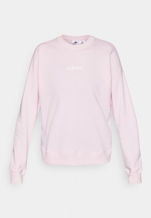 Jasnoróżowy sweter z miękkiego materiału, z okrągłym dekoltem, długimi rękawami i białym logo Adidas z przodu.