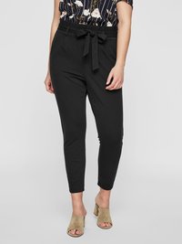 Black tailored trousers with a fitted silhouette, a belted waist, and soft fabric. Paired with a floral print blouse and heeled sandals.
