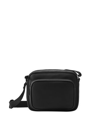 Compact black crossbody bag with adjustable strap and two zippered compartments on the front.