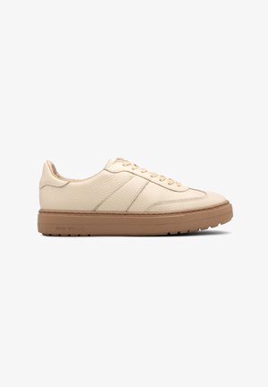 Cream leather sneakers with a textured finish, featuring a beige rubber sole and tonal stitching, lace-up design with side accents.