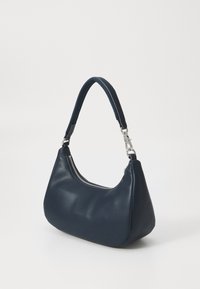 Hobo bag in navy faux leather with a curved shape, a zippered opening, and a textured shoulder strap featuring silver hardware accents.