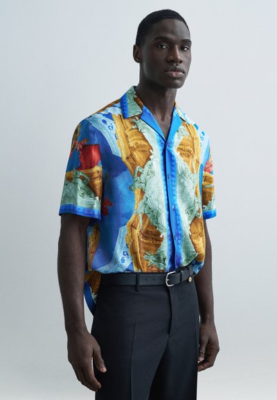 Short-sleeve shirt featuring a colorful graphic pattern, predominantly blue, orange, and green, with a button-up front and contrasting collar.
