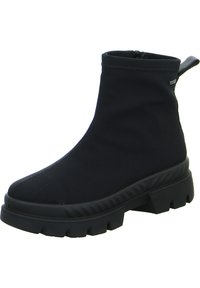 Bottines noires en tissu avec une semelle en caoutchouc, dotées d'une fermeture éclair, d'une semelle épaisse et d'une languette à l'arrière.
