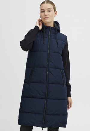 Gilet matelassé navy avec capuche, motif quilté et fermeture éclair à l'avant. Doté de poches latérales et d'une silhouette décontractée. Manches noires.
