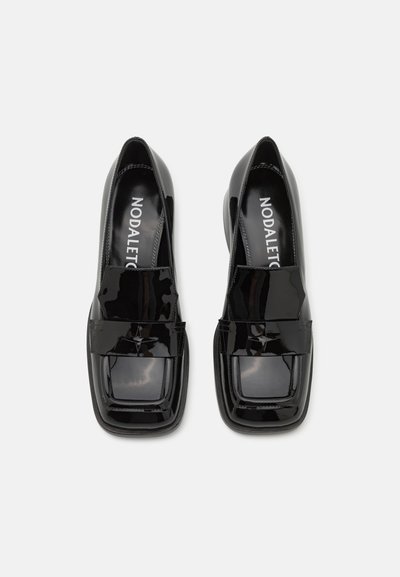 Black patent leather heeled shoes with a square toe and a glossy finish. Features a wide strap across the front and rounded edges.