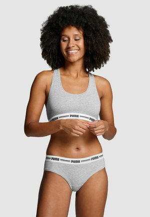 Light gray sports bra and matching panties with black Puma logo waistband and trim. Smooth, stretchy fabric, racerback design, minimal seams.
