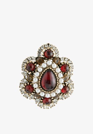 Brooch with a large red teardrop center stone, surrounded by white pearls, smaller red and brown stones, and clear crystals in gold setting.