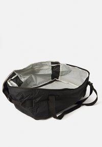 Black fabric duffel bag with a textured exterior, gray interior lining, dual handles, and multiple zippered pockets. Spacious and practical design.