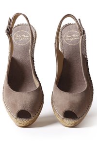 Brown suede espadrille shoes with an open toe, slingback design, and woven jute sole. Textured fabric and stitching details visible.
