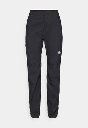 Pantalons d'extérieur noirs en tissu léger, avec une fermeture à bouton, des poches zippées et un petit logo sur la cuisse gauche.