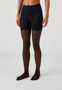 Zwarte, ondoorzichtige panty's van een glad, rekbaar materiaal, met een hoge taille en een transparante afwerking op de benen, die eindigen bij de enkels.