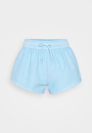 Light blue athletic shorts made of lightweight fabric, featuring an elastic waistband with a drawstring and a circular logo patch.