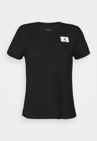 T-shirt in cotone nero con maniche corte, scollatura rotonda e un patch con logo bianco che presenta una silhouette sul lato sinistro del petto.