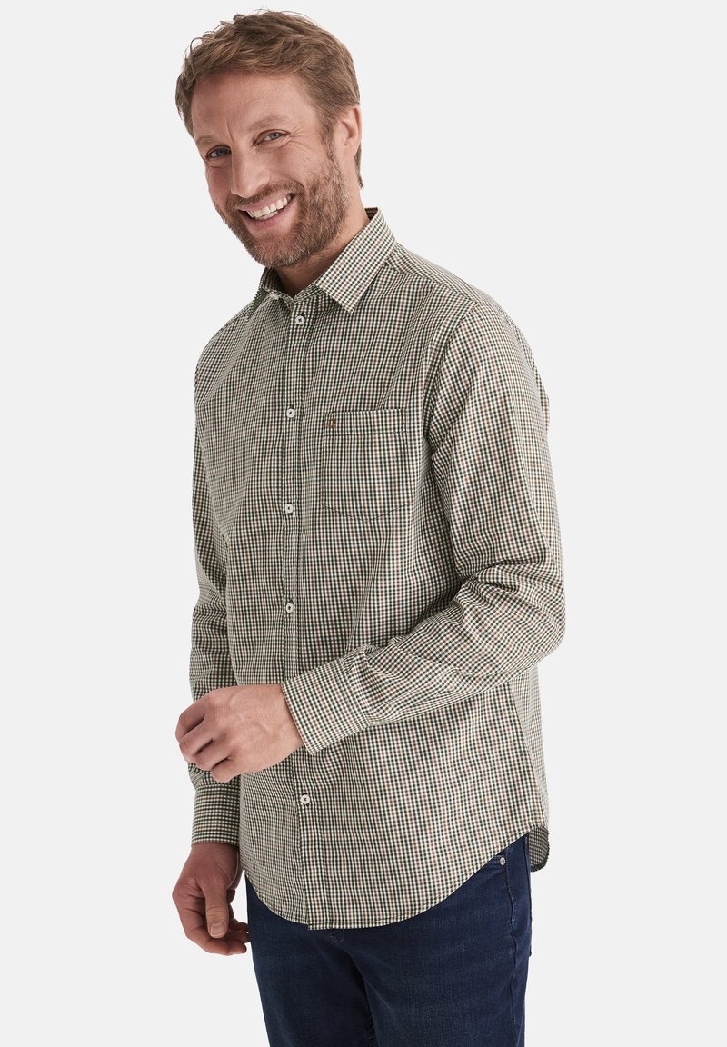 Grün-weiße karierte Hemdjacke mit langen Ärmeln, Kragen und Brusttasche, kombiniert mit dunkelblauen Jeans.