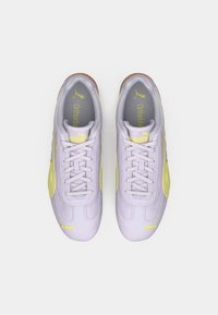 Lilac sneakers with yellow accents, featuring a smooth texture, lace-up design, and tan sole. Ortholite insole is visible inside.