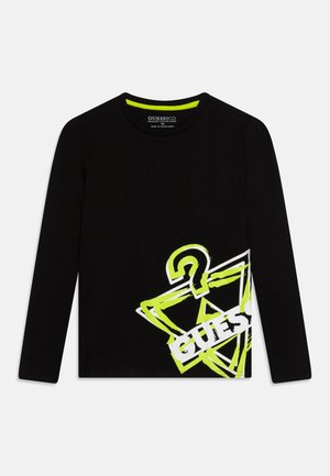 Sort langærmet skjorte med neongul og hvid stiliseret spørgsmålstegn og "GUESS?"-logo nederst foran på højre side.