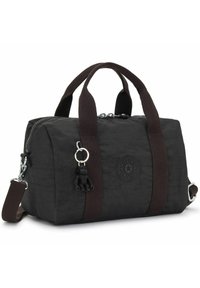 Black duffle bag with brown fabric handles, zip closure, logo patch, and a black monkey keychain charm attached. Textured material.