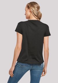 Black short-sleeve T-shirt with a round neckline, made from soft material, featuring a relaxed fit and a curved hem design.