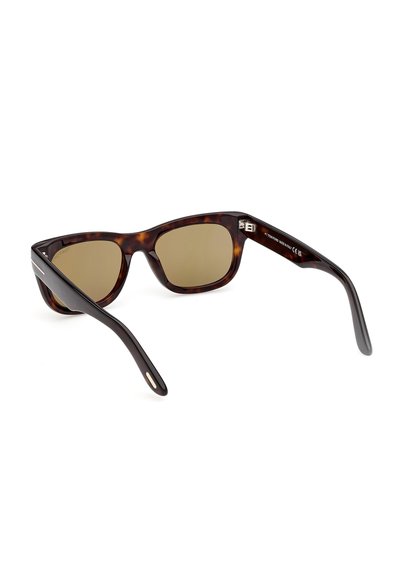 Tortoiseshell rectangular sunglasses with brown tinted lenses and wide black arms resting on a white surface.